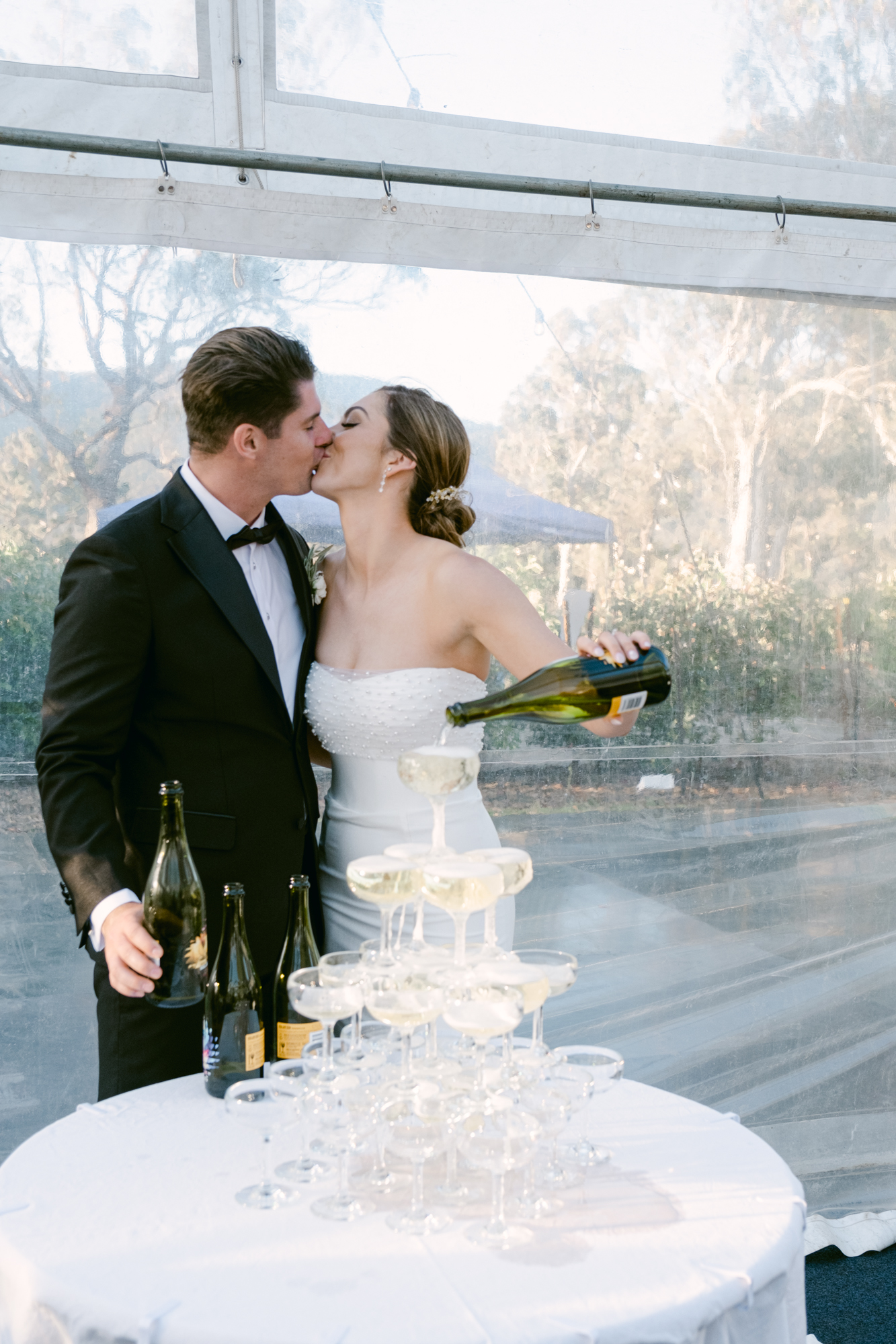 Bride and groom celebrating thier wedding with a champagne tower at the receptions in Bowral Southern highlands wedding venue