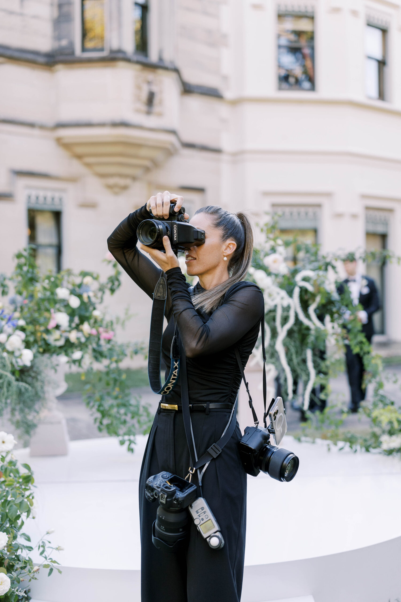Wedding content creator capturing behind-the-scenes footage on an iPhone.
